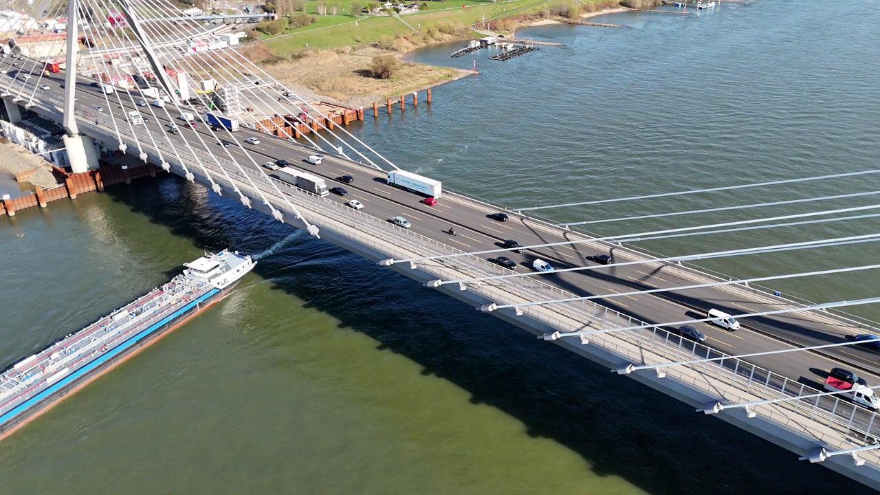 Drone circles tower creating dynamic perspective of bridge