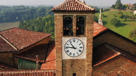 Aerial-view-away-from-the-bell-tower,-sunny-evening-in-Scurzolengo,-Asti,-Italy