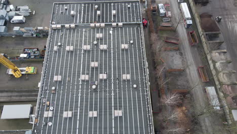 Jib-down-of-construction-workers-walking-on-rooftop