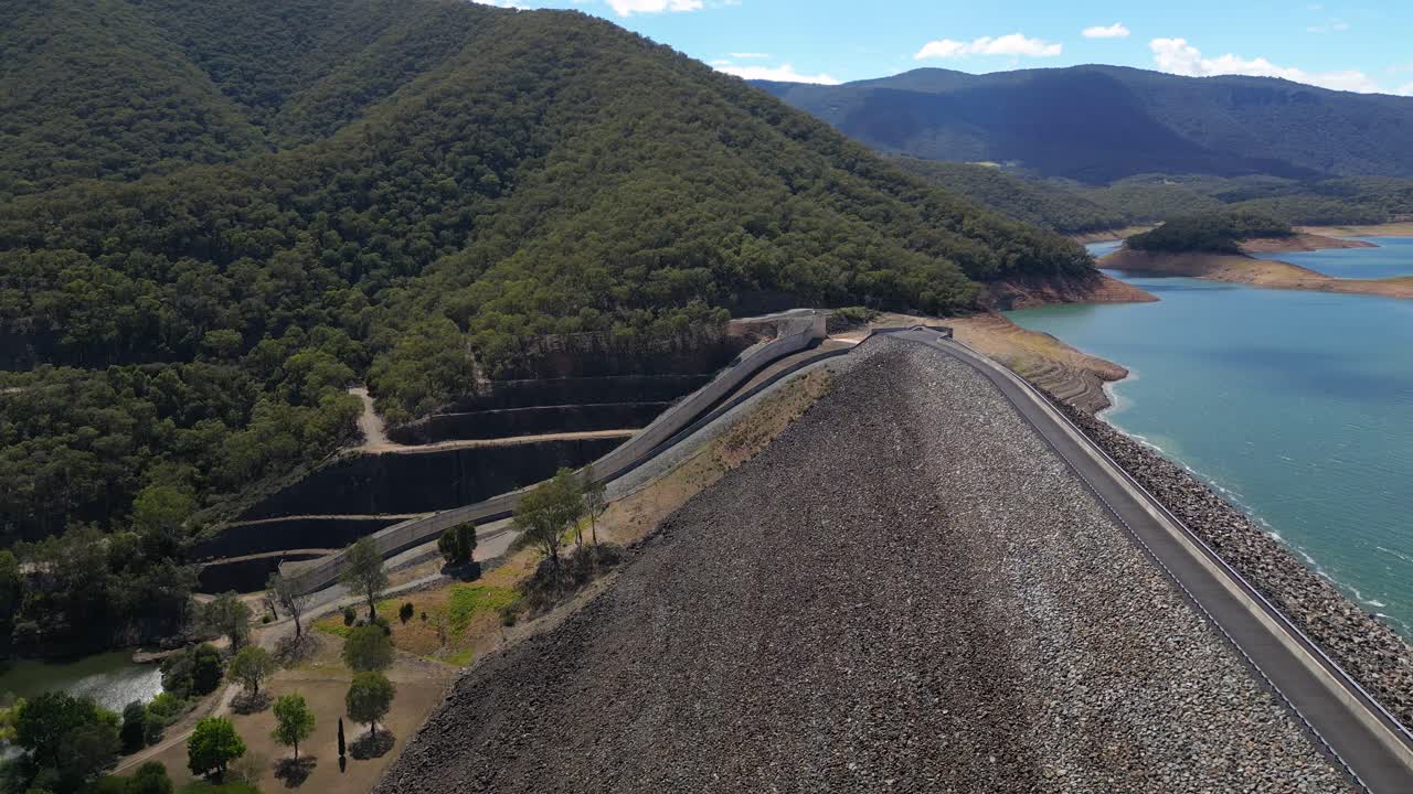 Approaching aerial views over the Blowering Dam, spillway and Reservoir, New South Wales alpine region.