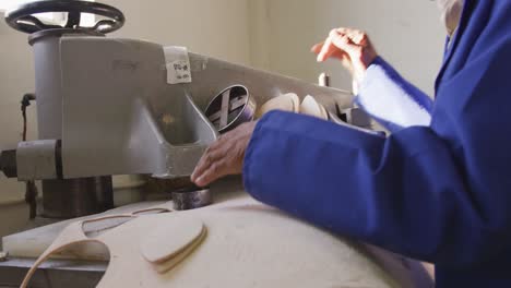 close up view of mixed race man working in factory