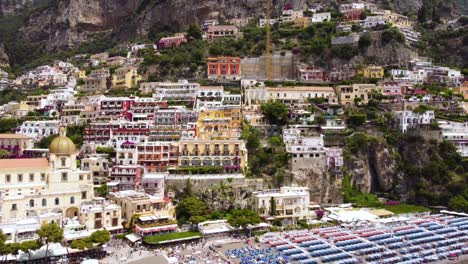 aerial drone footage of marina grande beach, chiesa of santa maria assunta in positano, amalfi coast, campania, italy