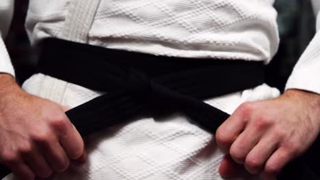 man in black belt standing in fitness studio