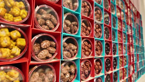 assorted chocolate covered nuts in display boxes