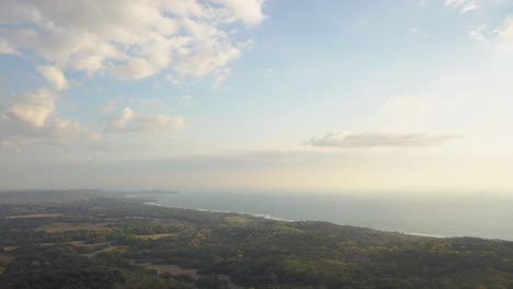 beautifu sunrise drone shot over the lush mountians overlooking the beach