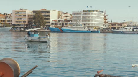 a greek fishing boat motors in the port of mytilene