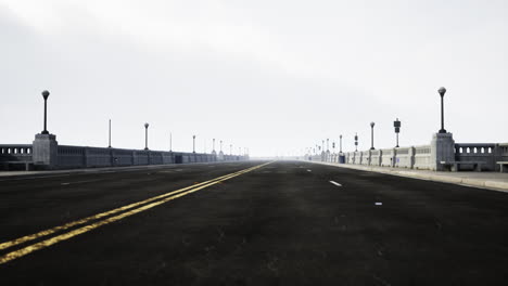 empty bridge road in misty morning