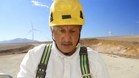 Male-engineer-working-in-the-wind-farm-4k