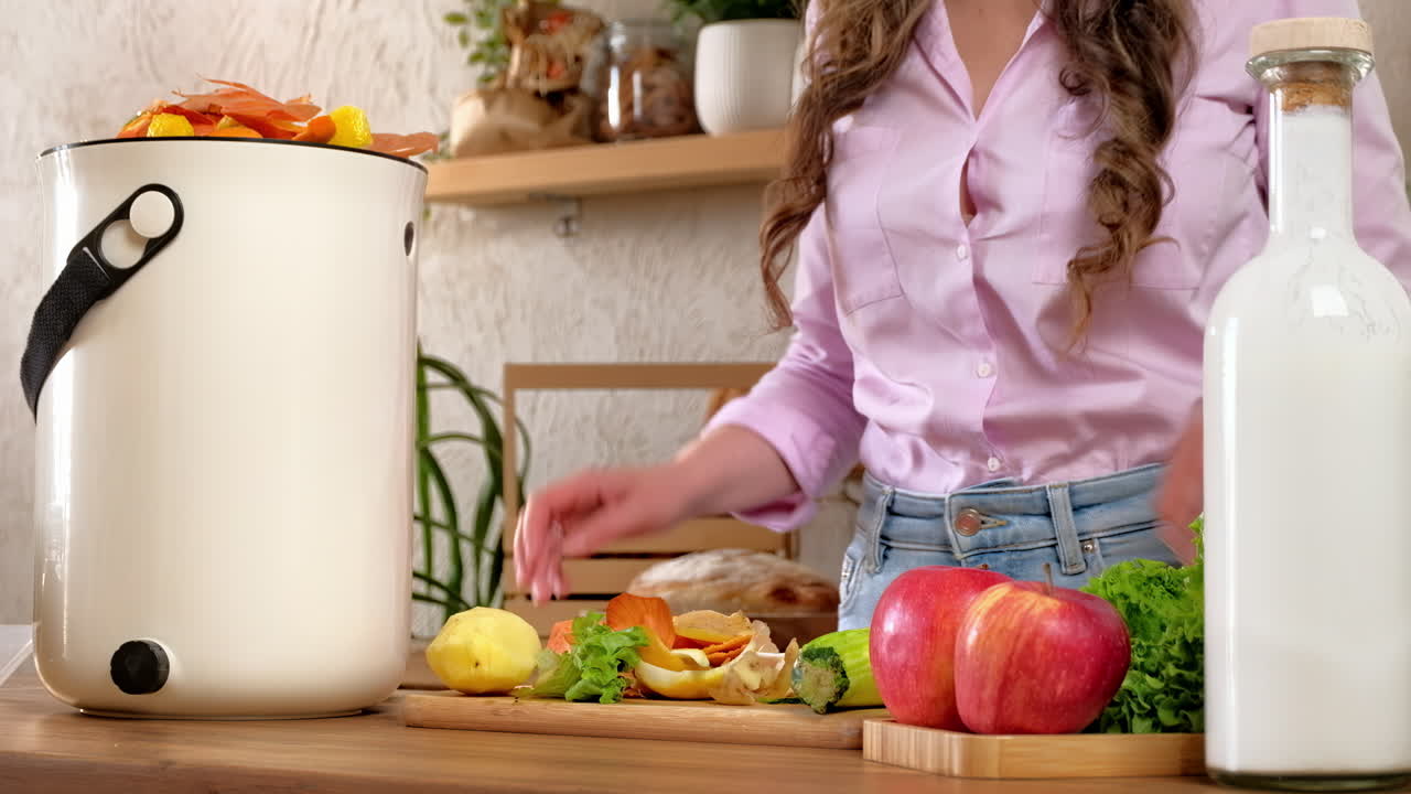 Woman peeling vegetables and recycling organic waste by composting in the Bokashi in the kitchen