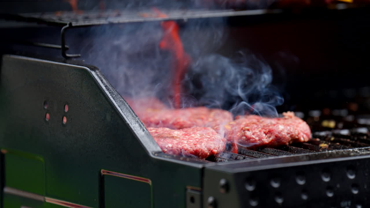 Grilling Fresh Beef Patties. Slow Motion Shot