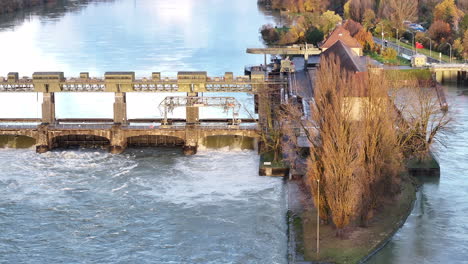 rhine river high water level at hydroelectric power plant augst switzerland, drone back truck 4k