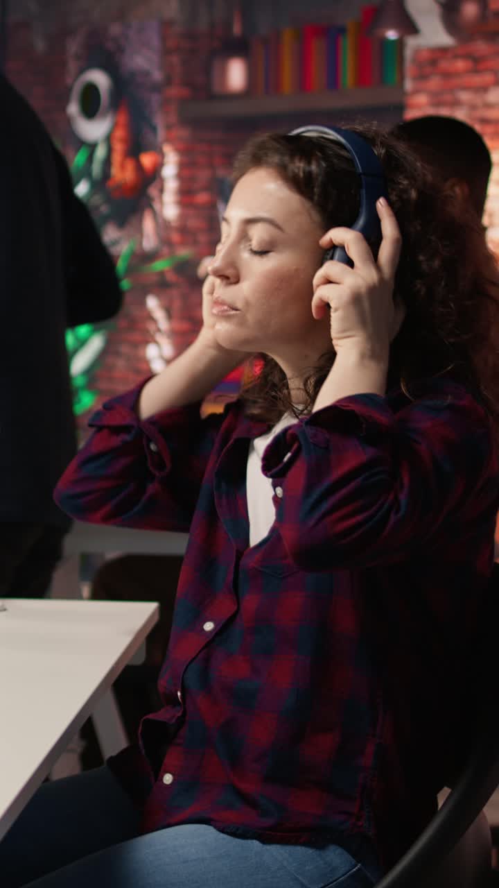 Vertical video Startup IT expert looking for company security vulnerabilities while listening music