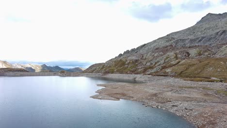 Lake-surrounded-by-hills-and-rocky-areas-in-Switzerland,-Lake-Naret