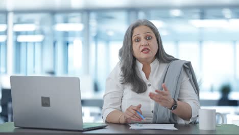 Angry-Indian-senior-businesswoman-shouting-to-someone