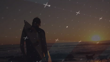 surfer holding surfboard on rocky shoreline at sunset, with cross-shaped light overlay for travel