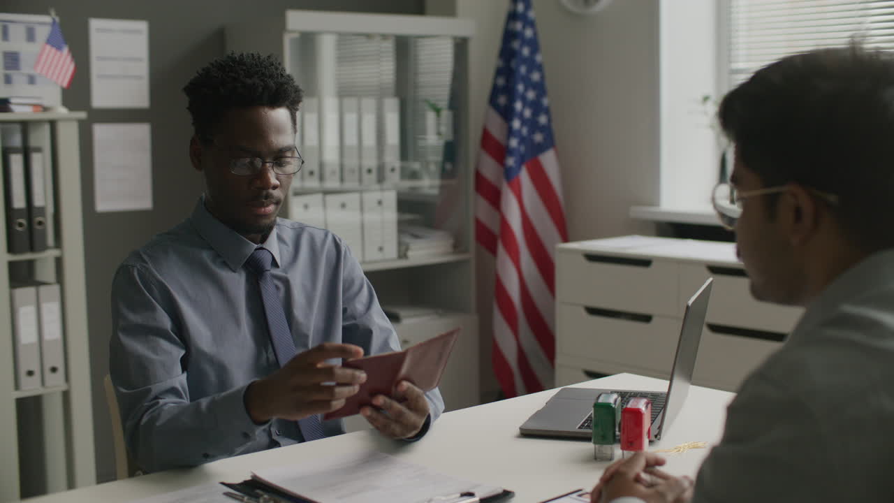 Visa Officer Reviewing Passport during Immigration Interview at US Embassy
