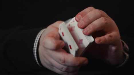 close up of a pair of hands and a deck of playing cards showing off with tricks, flourish and spread in 4k