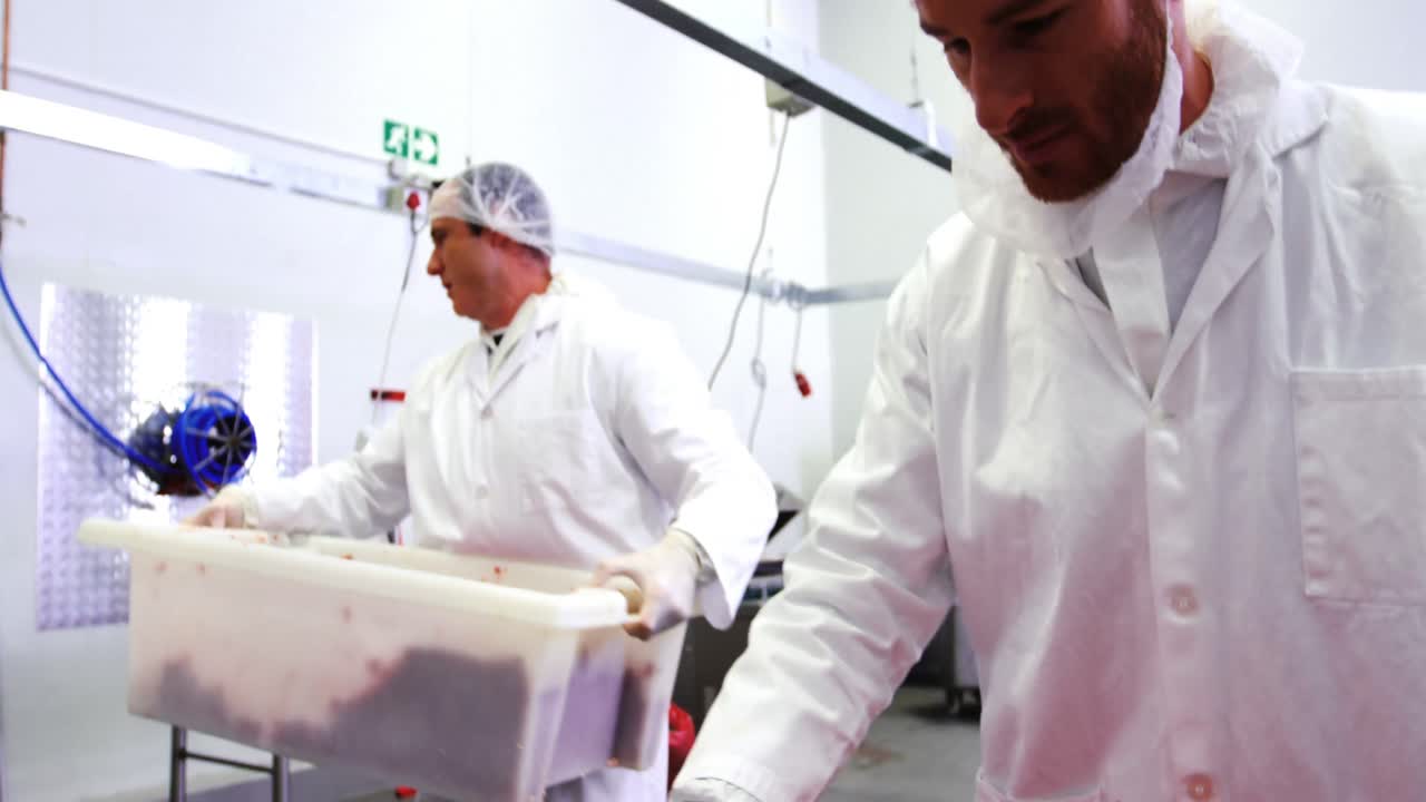Butchers preparing minced meat