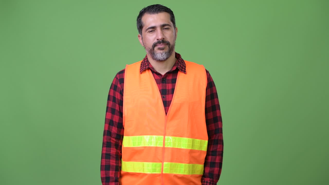 Handsome Persian bearded man construction worker giving handshake
