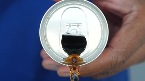 close up of a can of soda being poured