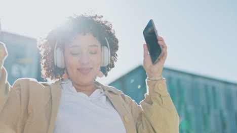 Headphones,-phone-and-black-woman-in-city-dancing