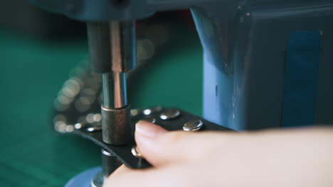 professional designer fixes metal accessories on choker