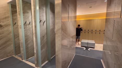 timelapse of asian millennial man exiting shower and dressing up in luxurious changing room