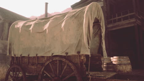 old west covered wagon in a frontier town