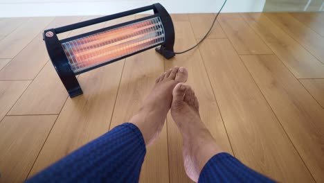 warming up feet by a heater