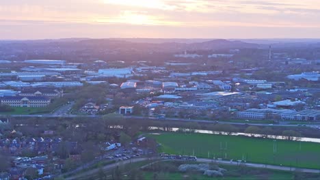 A-slow-zoom-out-shot-featuring-a-calm-light-pink-sunset-over-Nottingham,-England