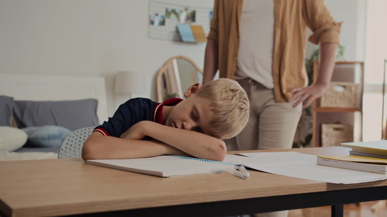 Sleeping Teenager Being Woken Up by His Father when Doing Homework