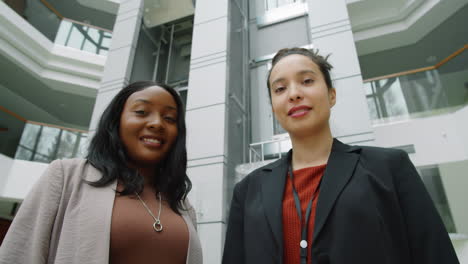 portrait of two multiethnic women in business center