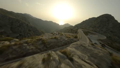 FPV-drone-shot-over-winding-Sa-Calobra-road-over-rocky-mountain-range-in-Mallorca,-Spain