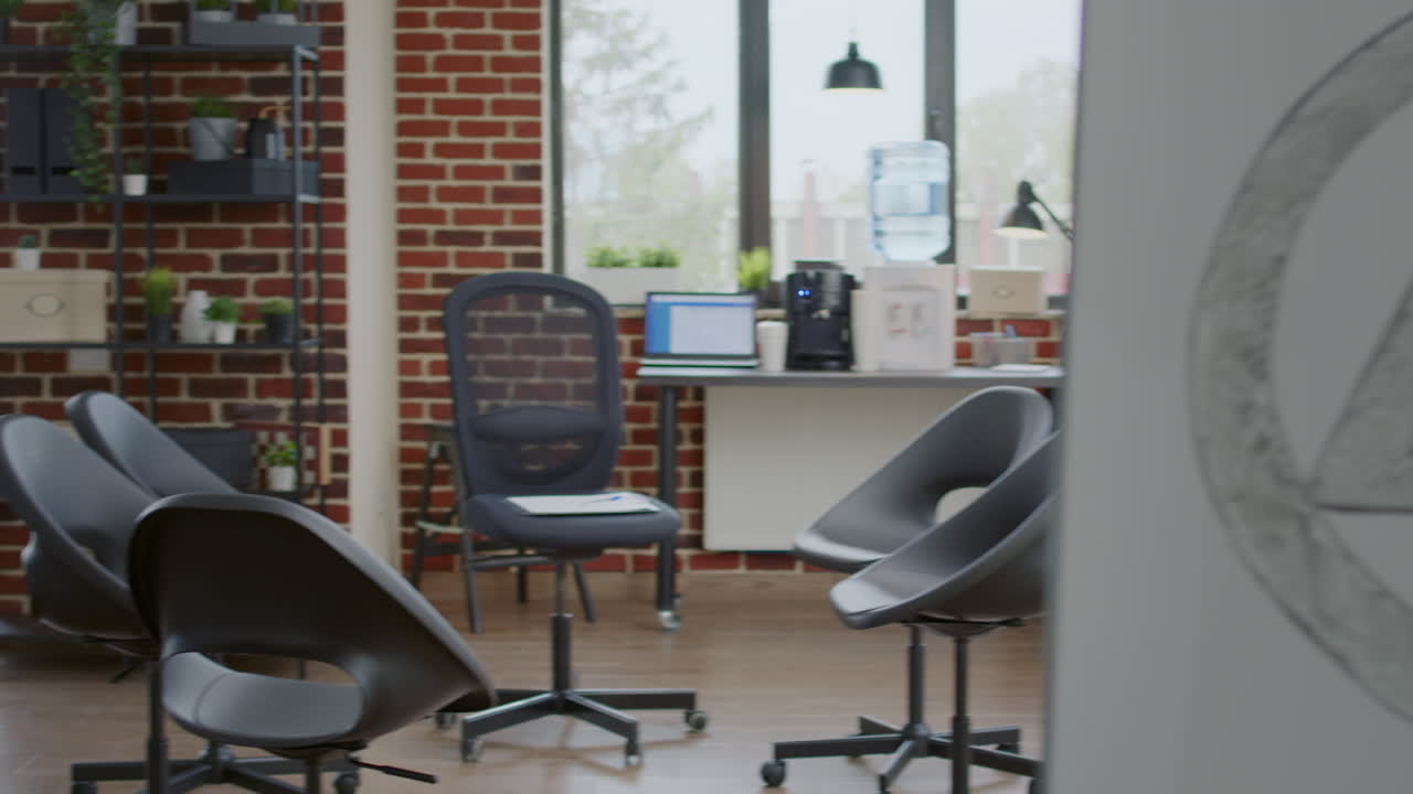Close up of white board with aa meeting symbol and chairs in empty space for group therapy