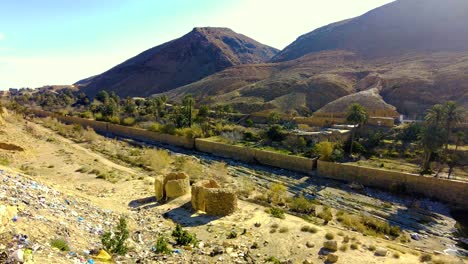 a canyon with ruined houses in a post apocalyptic setting