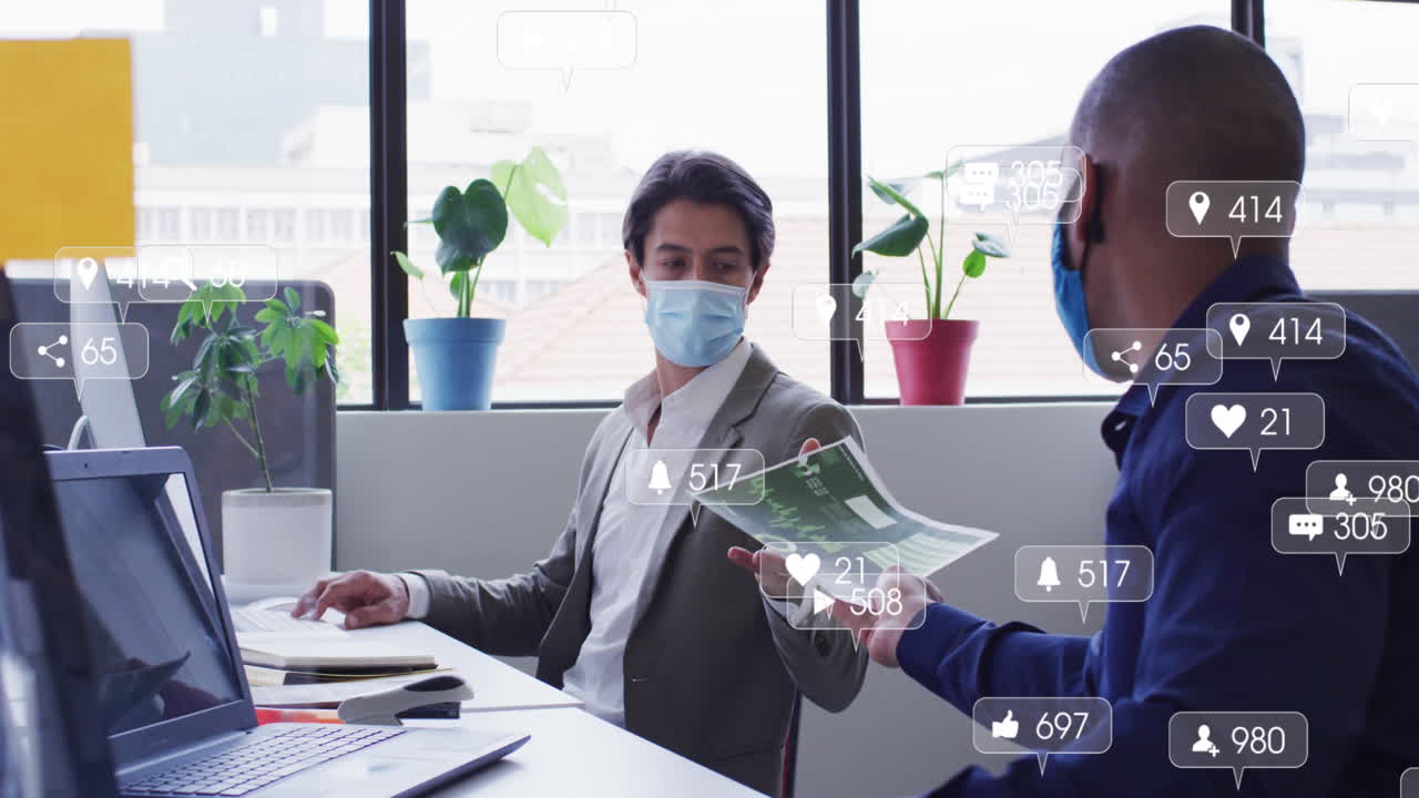 Animation of social media icons over diverse man passing a document to another man at office