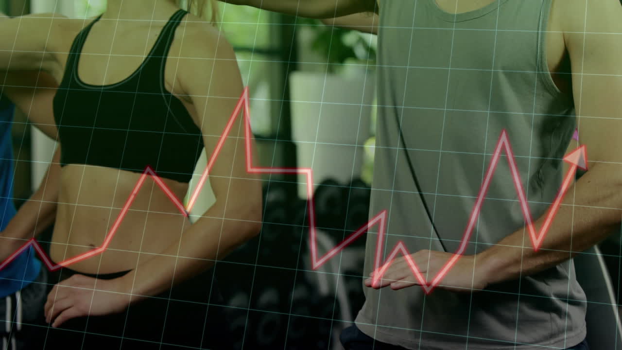 Fitness partners tracking armband metrics in gym, showing animated performance graph overlay