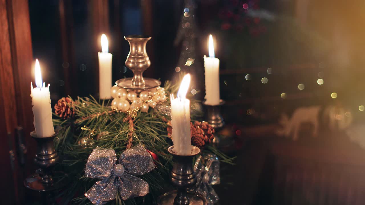 Christmas night candlestick on a windowsill with four burning candles. blurry bokeh