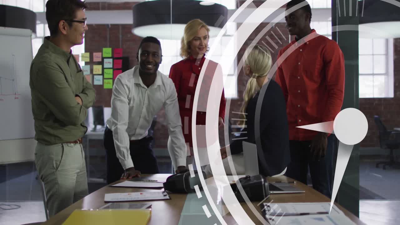 Animation of ticking clock icon against diverse colleagues discussing and smiling together at office