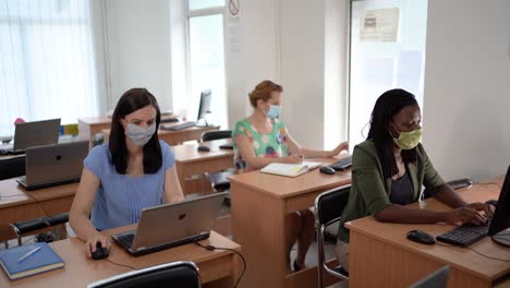 multietnic group of coworkers sitting in board room