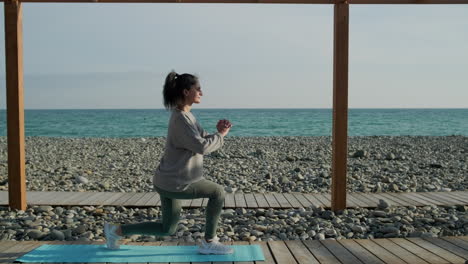 woman exercising on the beach