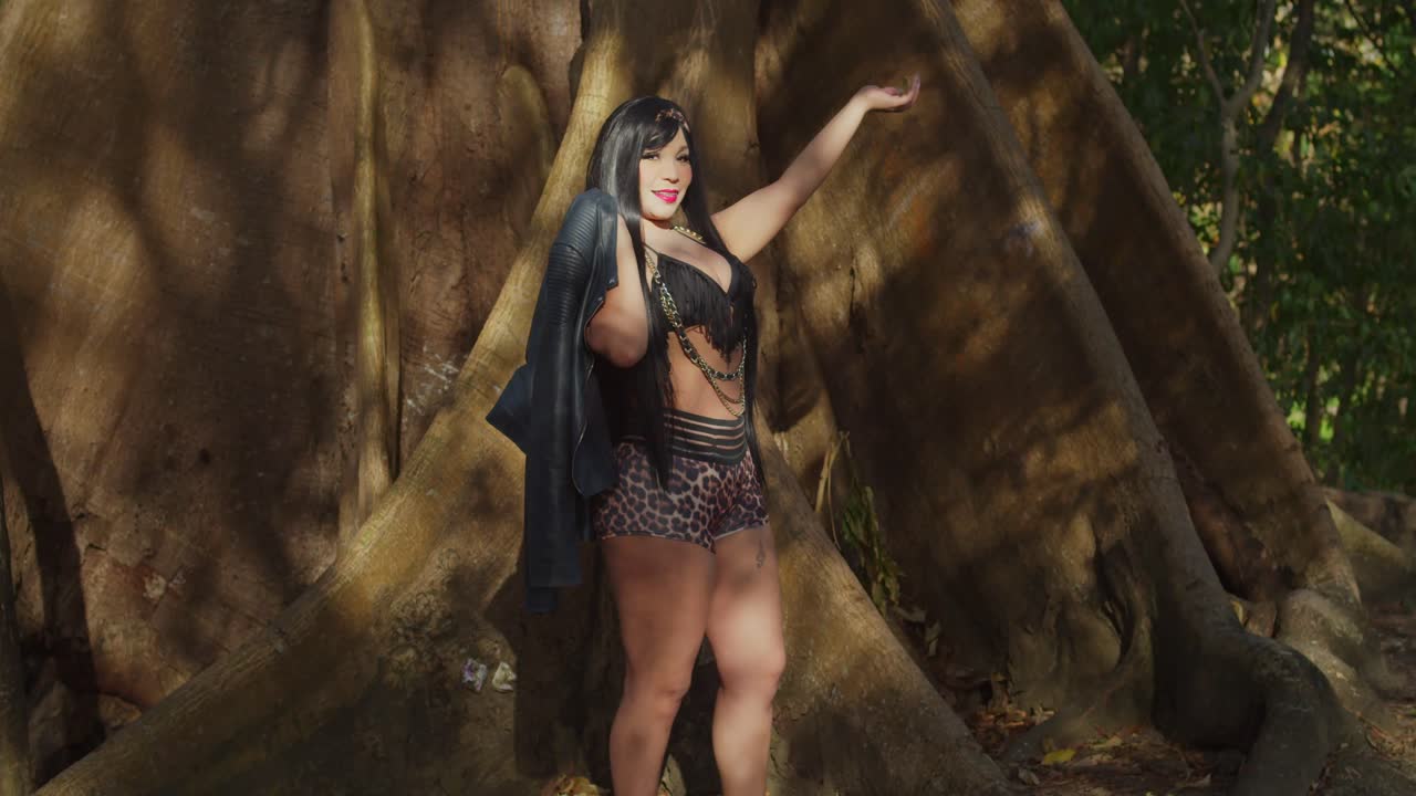 A woman in casual shorts strolling through a lush tropical park on the Caribbean island of Trinidad.