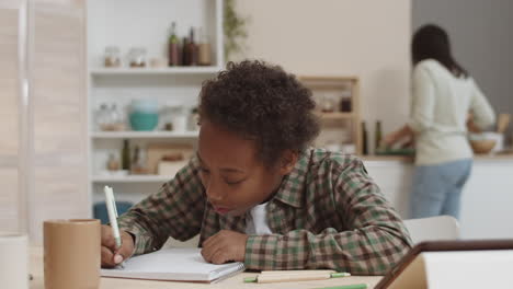 child doing homework in the kitchen