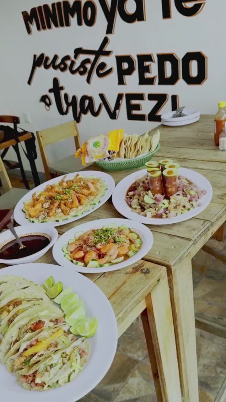 Variety of ready-to-eat shrimp-based dishes. Ceviche, tacos, aguachile, and consomme. Vertical shot