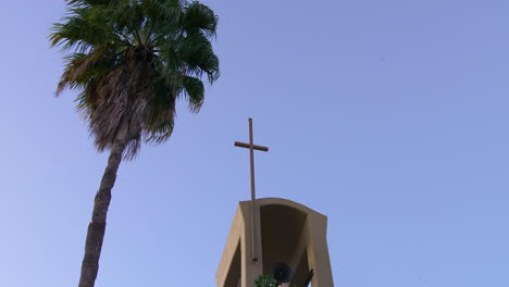 a church steeple with a tree next to it