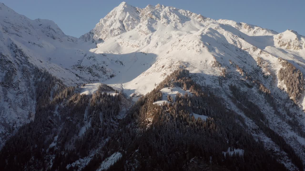 Aerial view of a mountain in winter with slight tilt up