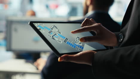 solar panels plant employee uses cad software on tablet to optimize layouts