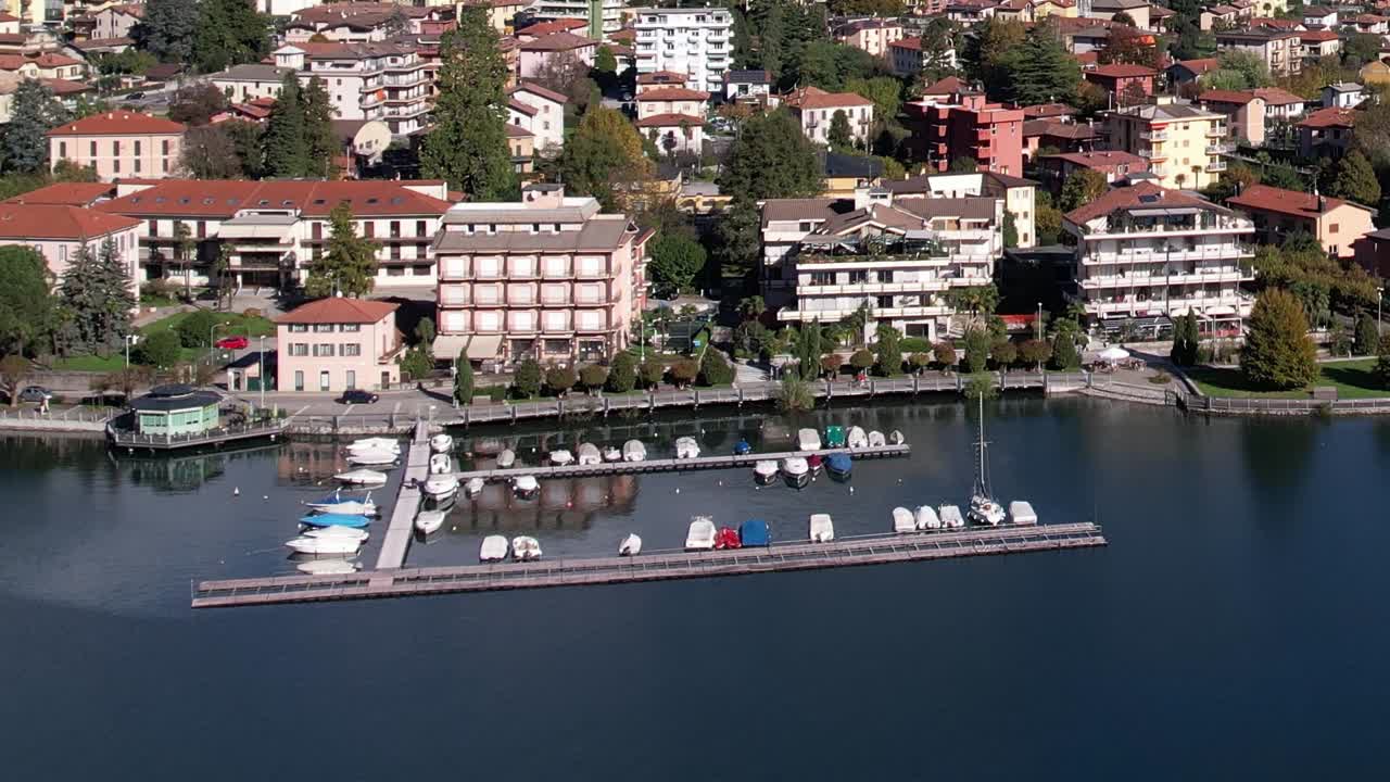 Stunning aerial view of colorful buildings by the lake in the Italian Alps