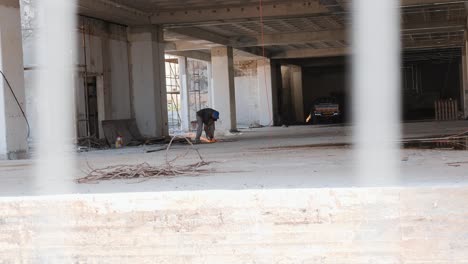 builder works at construction site. worker is welding. construction with builder