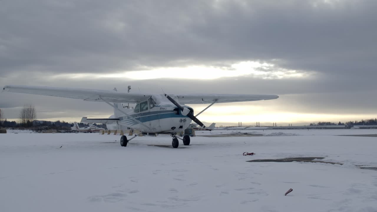 Static Shot of a Cessna C172 Propeller Airplane on a Snowy Winter Day